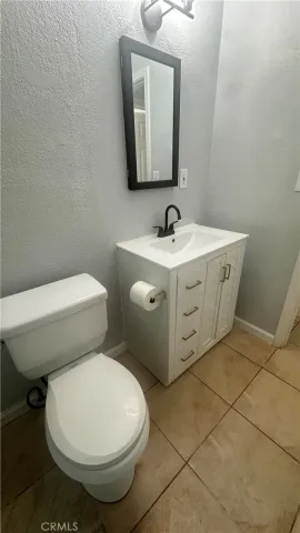 a bathroom with a double vanity sink toilet and shower