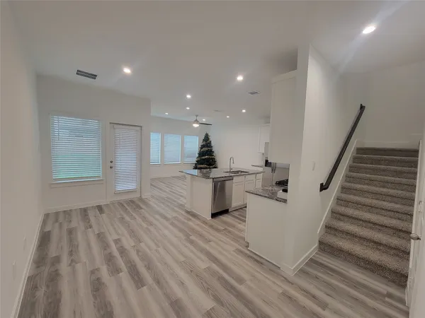 a view of kitchen with furniture and wooden floor