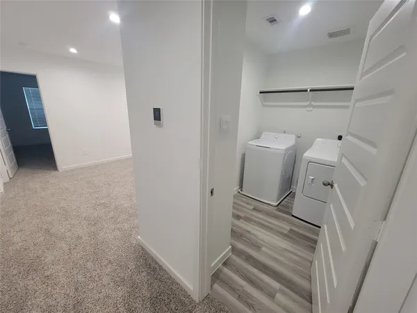 a white toilet sitting next to a bath tub