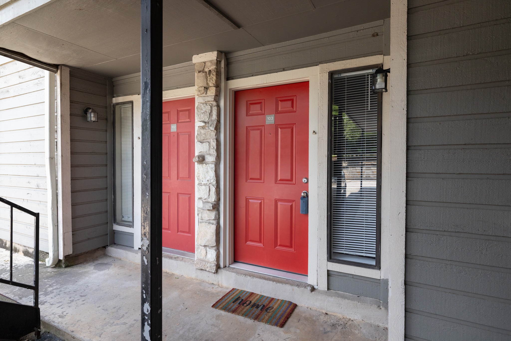 9079 Jollyville Road, Unit 301 Austin, TX 78759 - Photo 13 of 38 Bold red entry doors and stone accents create a welcoming facade for these modern residences.