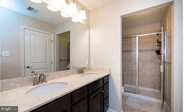 a bathroom with a sink double vanity and a mirror