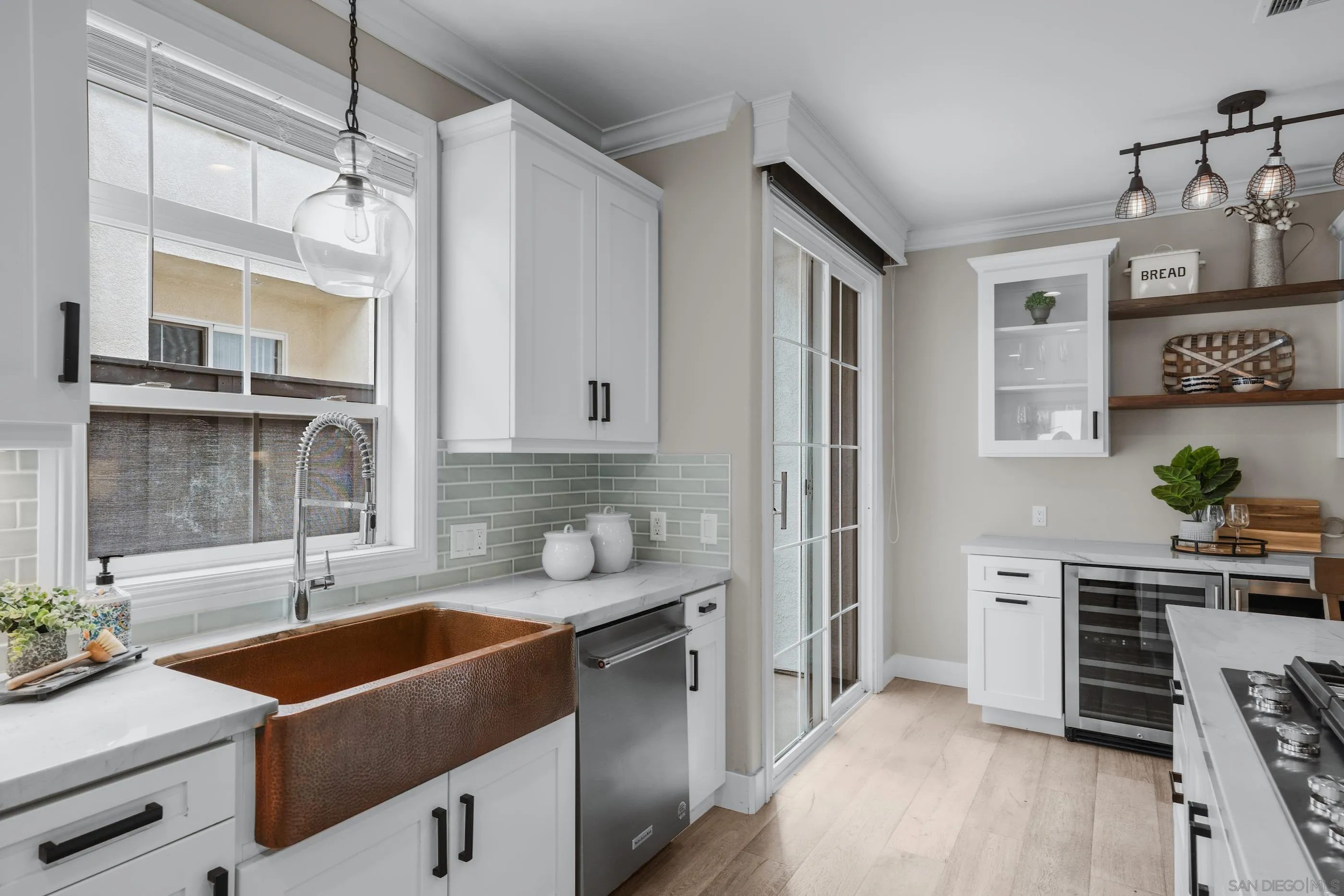 6402 Topmast Drive Carlsbad, CA 92011 - Photo 18 of 53 a kitchen with stainless steel appliances a sink stove and wooden floor