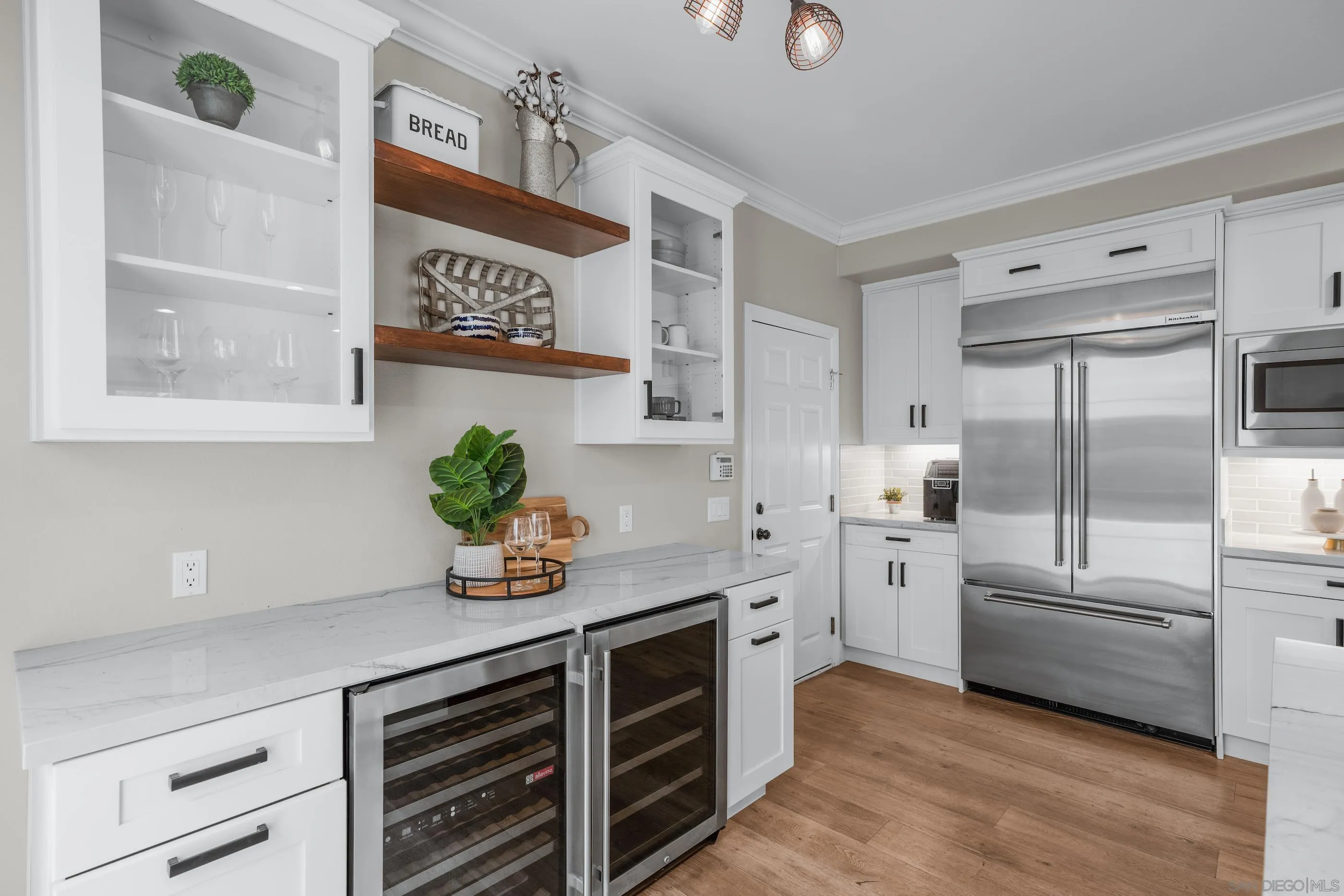 6402 Topmast Drive Carlsbad, CA 92011 - Photo 19 of 53 a kitchen with stainless steel appliances a sink cabinets and wooden floor