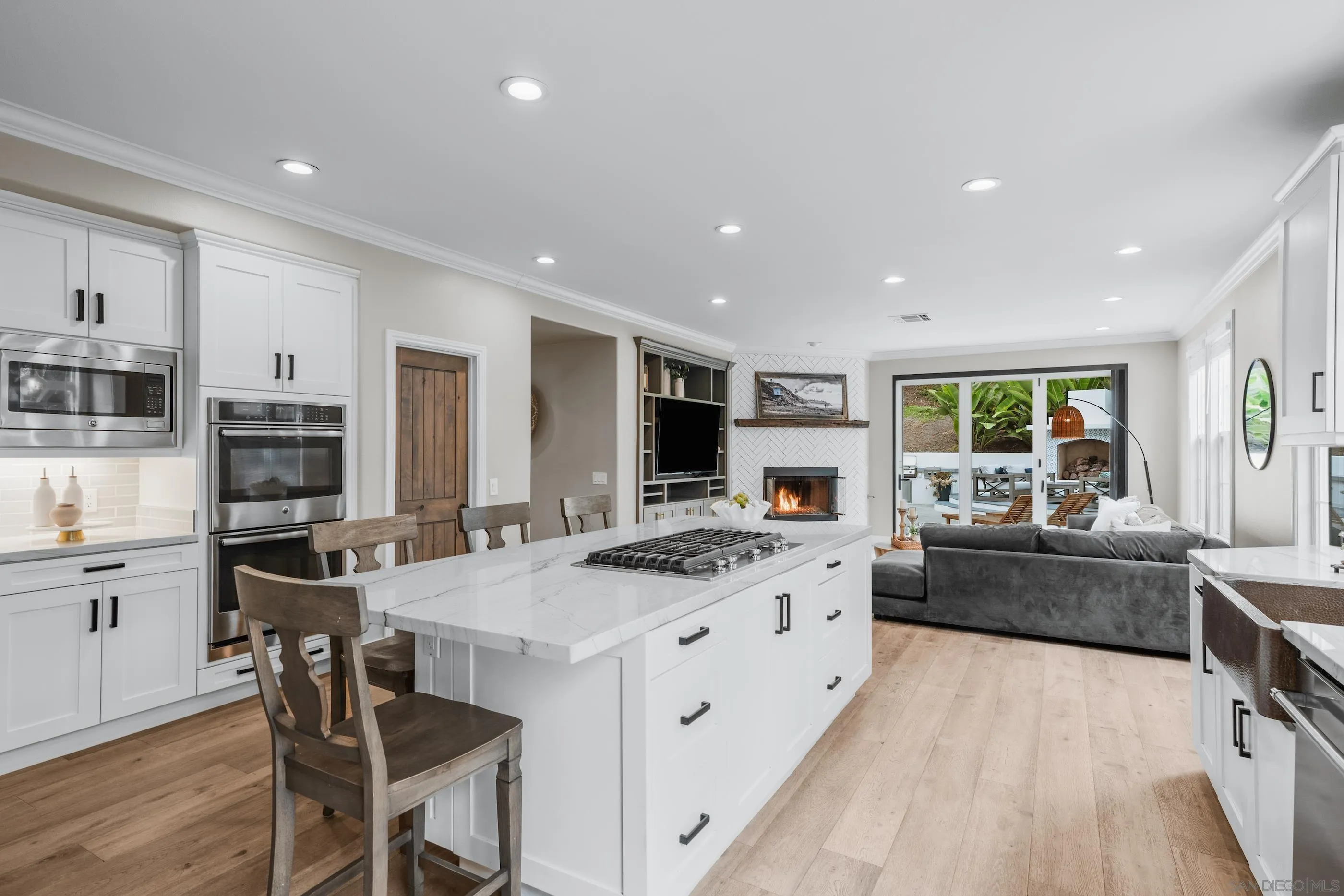 6402 Topmast Drive Carlsbad, CA 92011 - Photo 20 of 53 a kitchen with stainless steel appliances kitchen island granite countertop a stove and a refrigerator