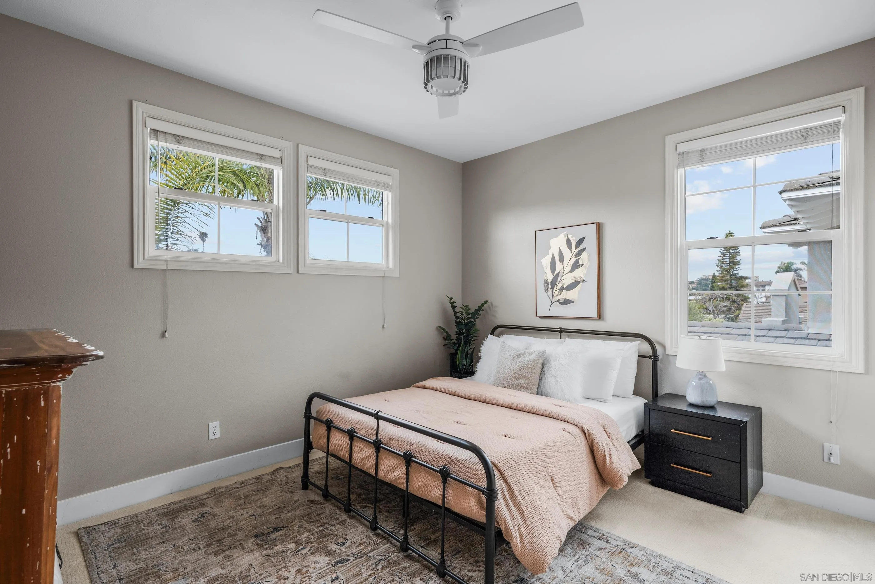 6402 Topmast Drive Carlsbad, CA 92011 - Photo 40 of 53 a bedroom with a bed and wooden floor