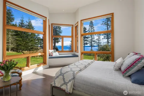 a bedroom with a large bed and a painting on the wall