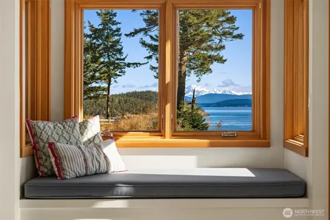 a view of a living room filled with furniture and a window