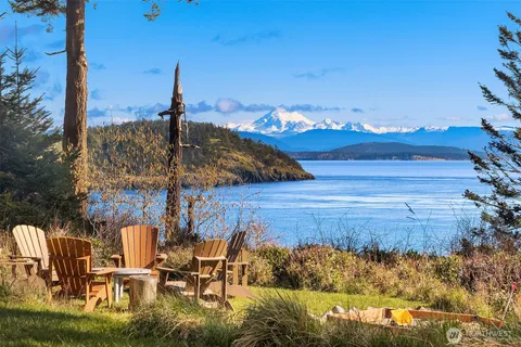 a view of a patio with lawn chairs under an umbrella