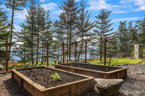 a view of a backyard with chairs and a fire pit