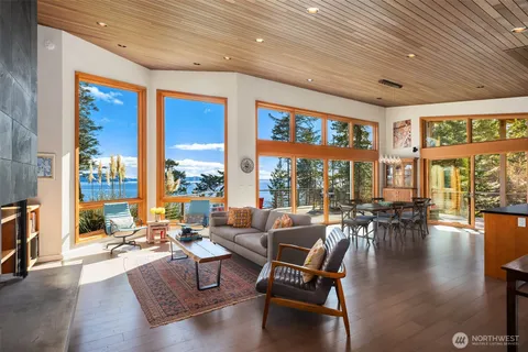 a living room with furniture and floor to ceiling windows