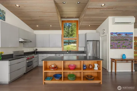 a kitchen with stainless steel appliances granite countertop a stove and cabinets