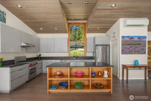 a kitchen with stainless steel appliances granite countertop a stove and cabinets