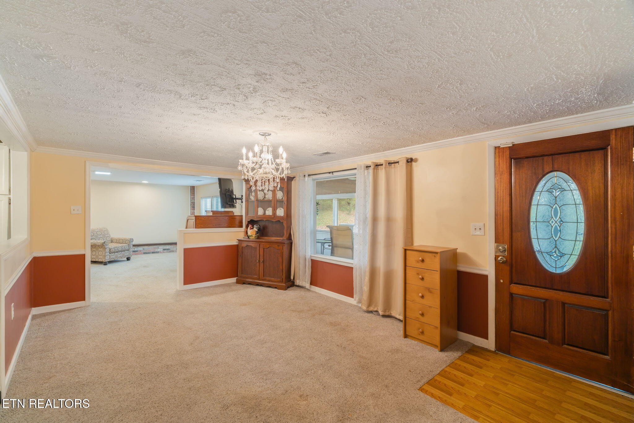 8404 Brickyard Road Powell, TN 37849 - Photo 15 of 49 a very nice looking room with a large window and a chandelier