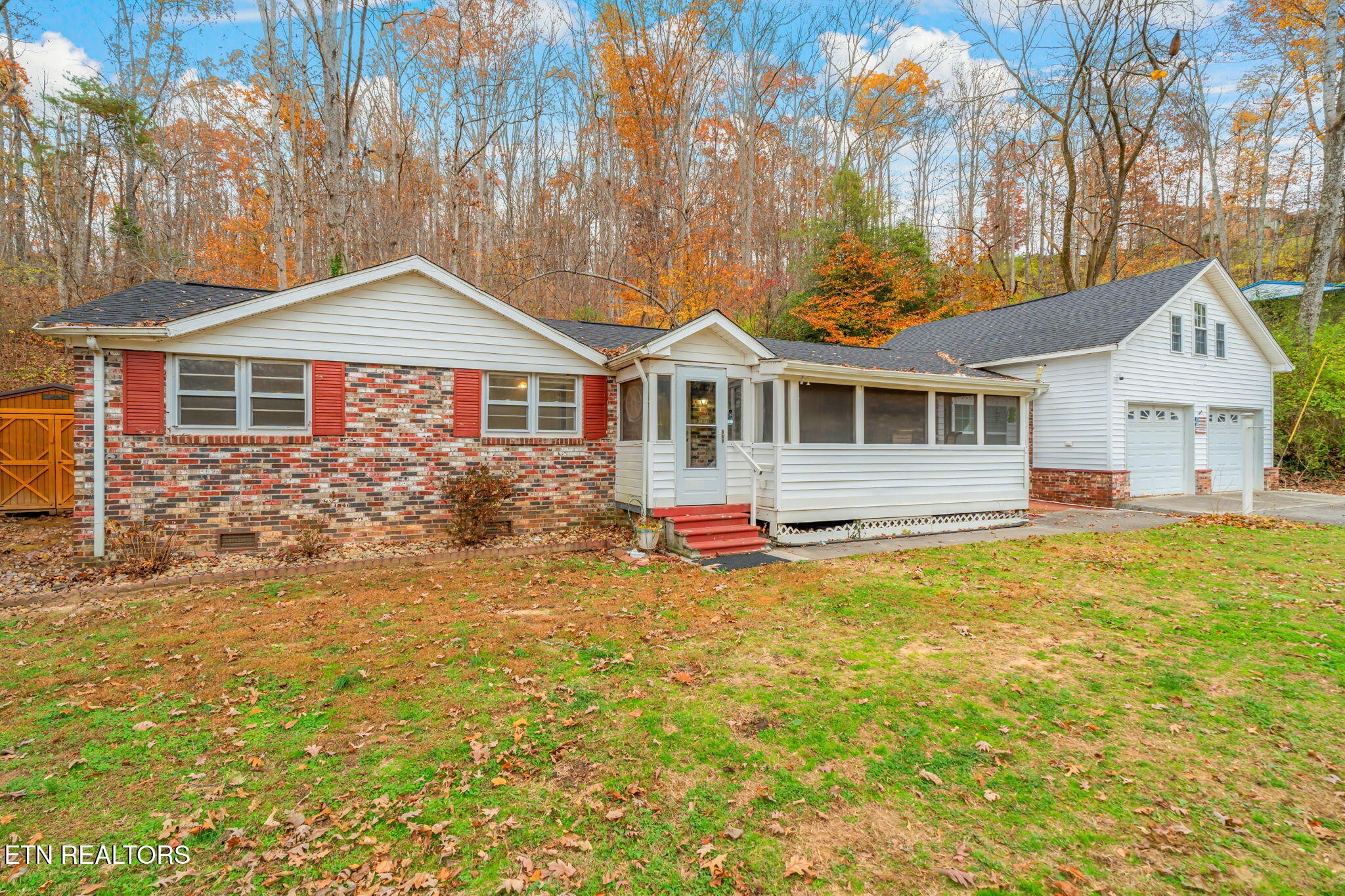 8404 Brickyard Road Powell, TN 37849 - Photo 5 of 49 a front view of a house with a yard table and chairs