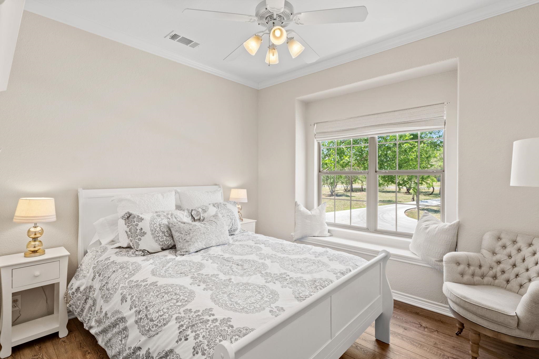 2409 Mormon Mill Road Marble Falls, TX 78654 - Photo 15 of 30 a spacious bedroom with a bed and a couch
