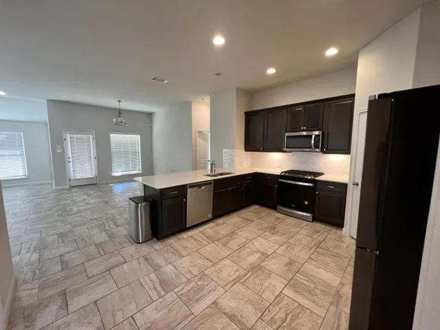 a spacious bathroom with a double vanity sink a large mirror and a shower