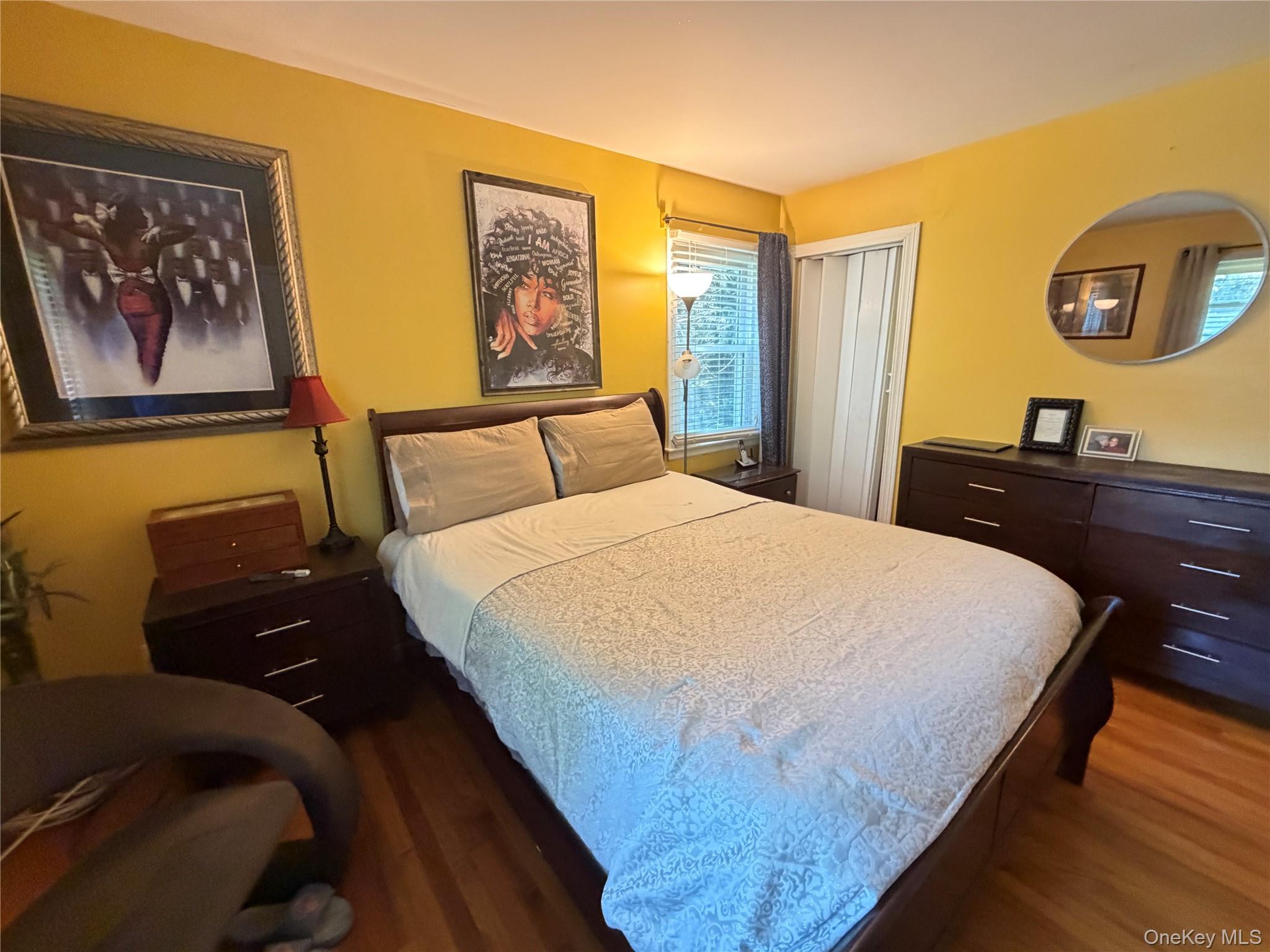 17 Mallory Road Spring Valley, NY 10977 - Photo 17 of 26 a bedroom with a bed and a painting on the wall