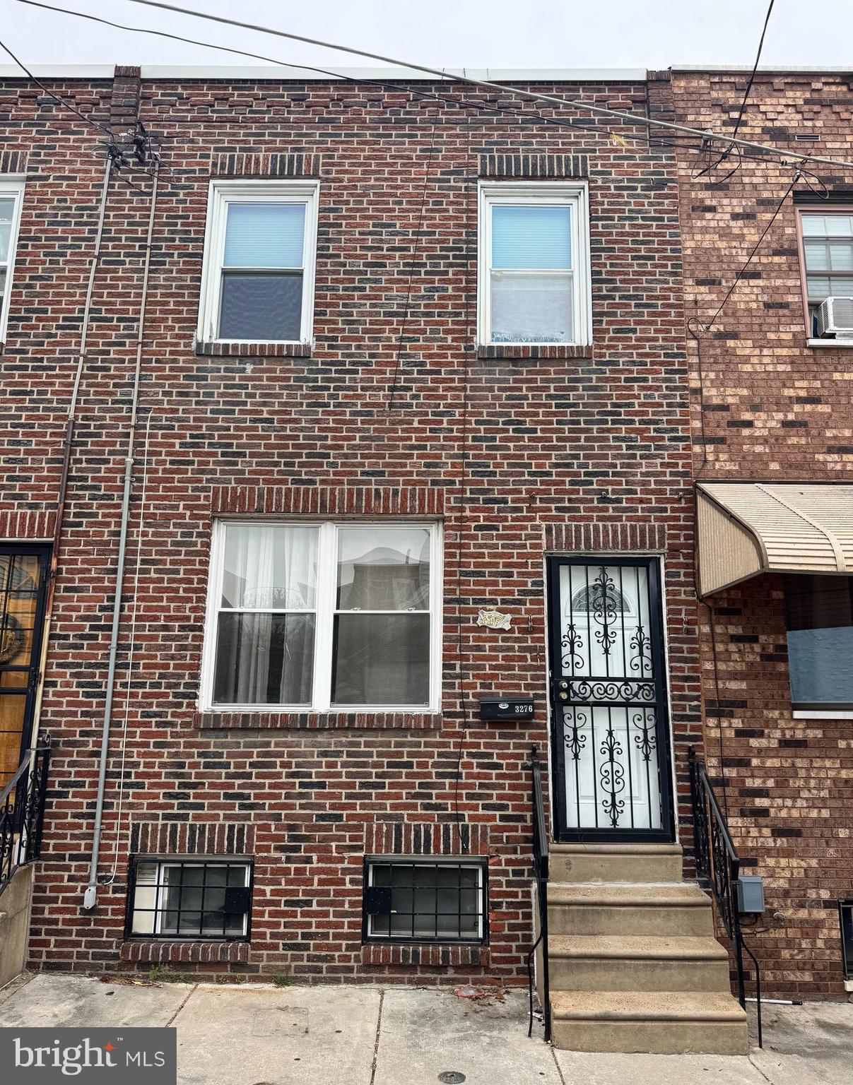 3276 Webb Street Philadelphia, PA 19134 - Photo 1 of 9 a front view of a building with a entryway