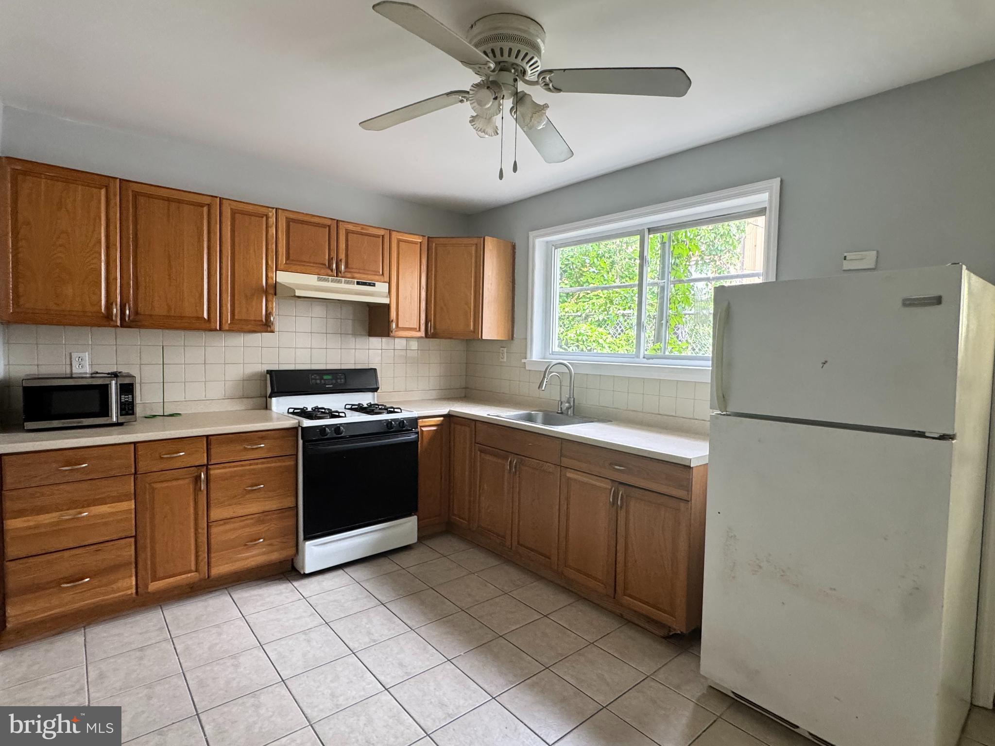 3276 Webb Street Philadelphia, PA 19134 - Photo 5 of 9 a kitchen with a refrigerator and a sink