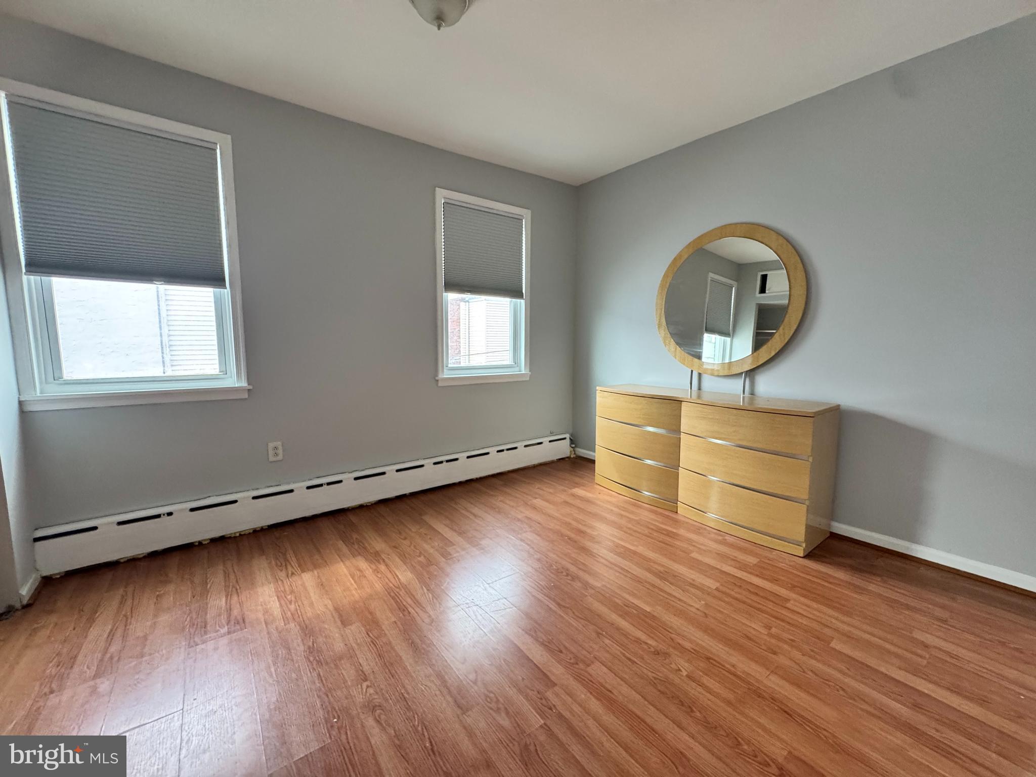 3276 Webb Street Philadelphia, PA 19134 - Photo 7 of 9 an empty room with wooden floor and windows