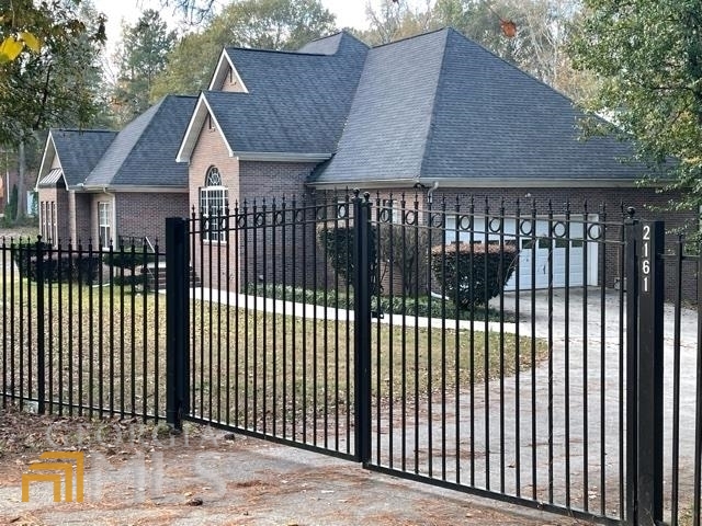 2161 East Atlanta Road Stockbridge, GA 30281 - Photo 1 of 1 a view of a house with a iron gate
