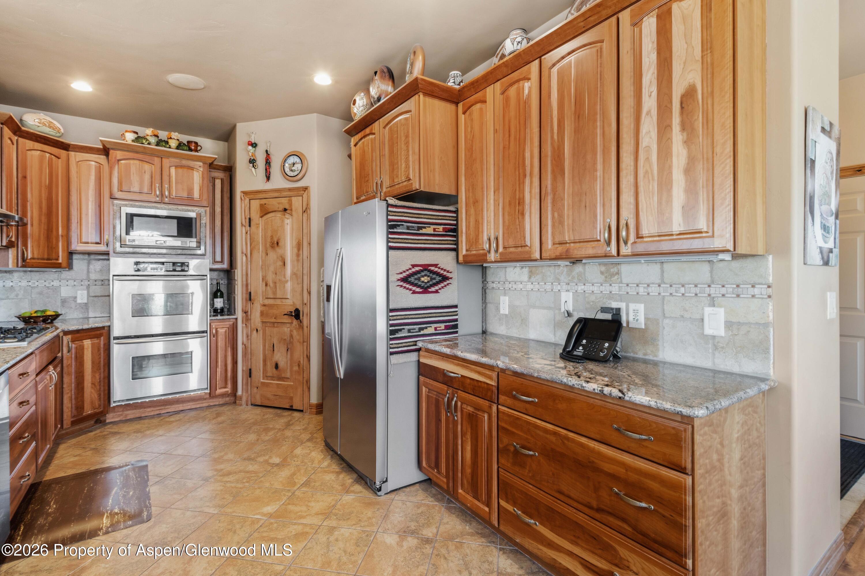 71 River View Place Parachute, CO 81635 - Photo 11 of 45 a kitchen with stainless steel appliances granite countertop a refrigerator and a sink