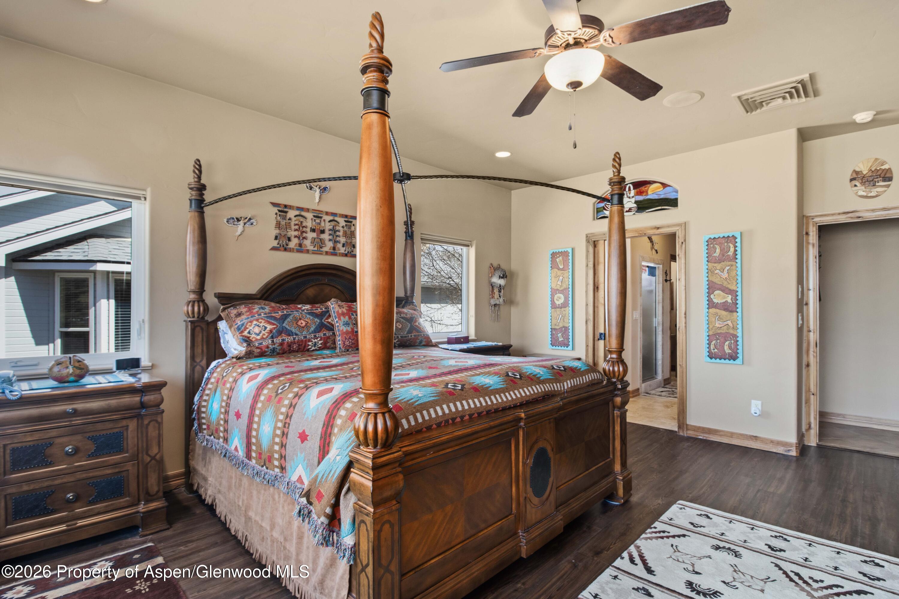 71 River View Place Parachute, CO 81635 - Photo 16 of 45 a bedroom with bed and a chandelier