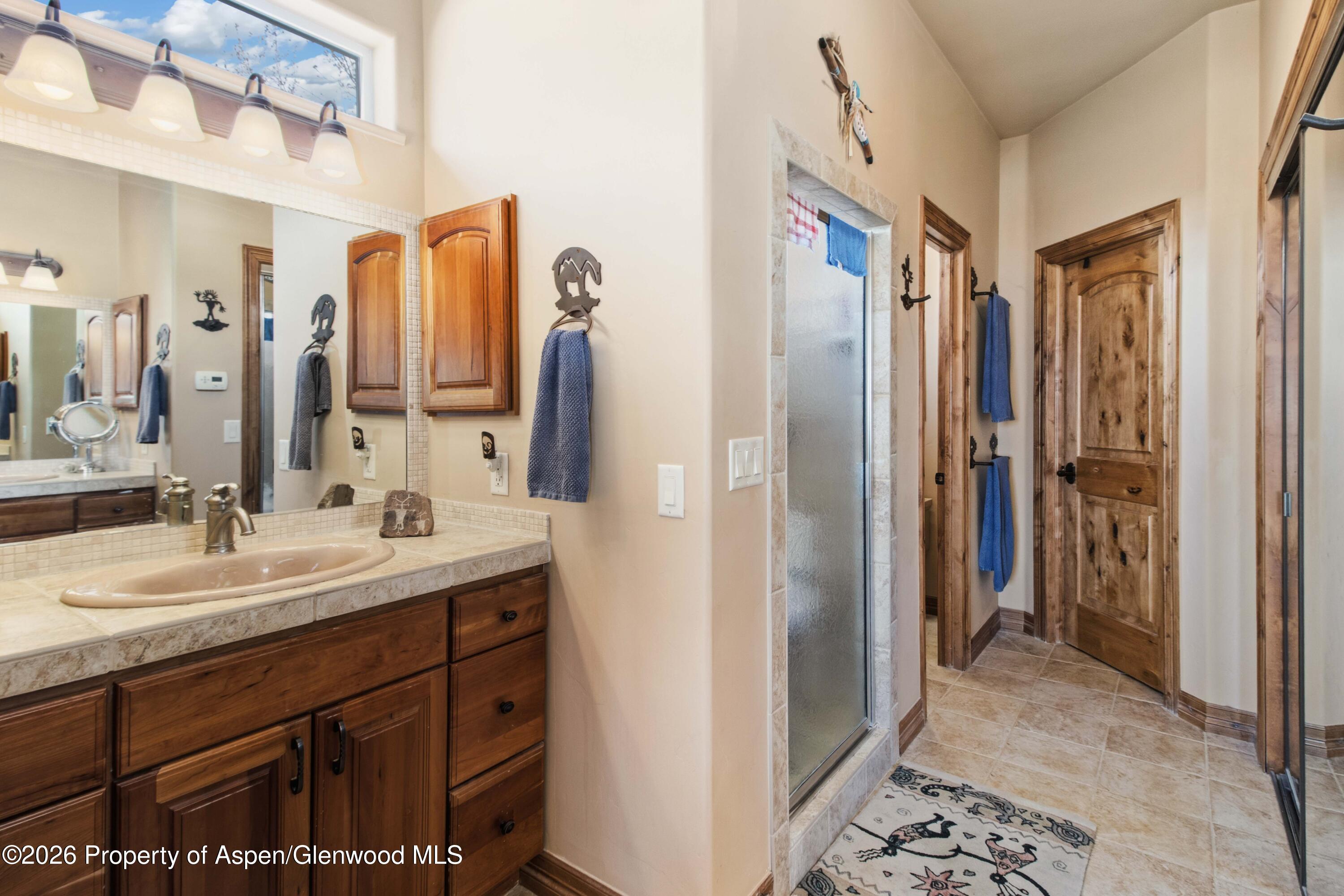 71 River View Place Parachute, CO 81635 - Photo 18 of 45 a spacious bathroom with a double vanity sink and a mirror