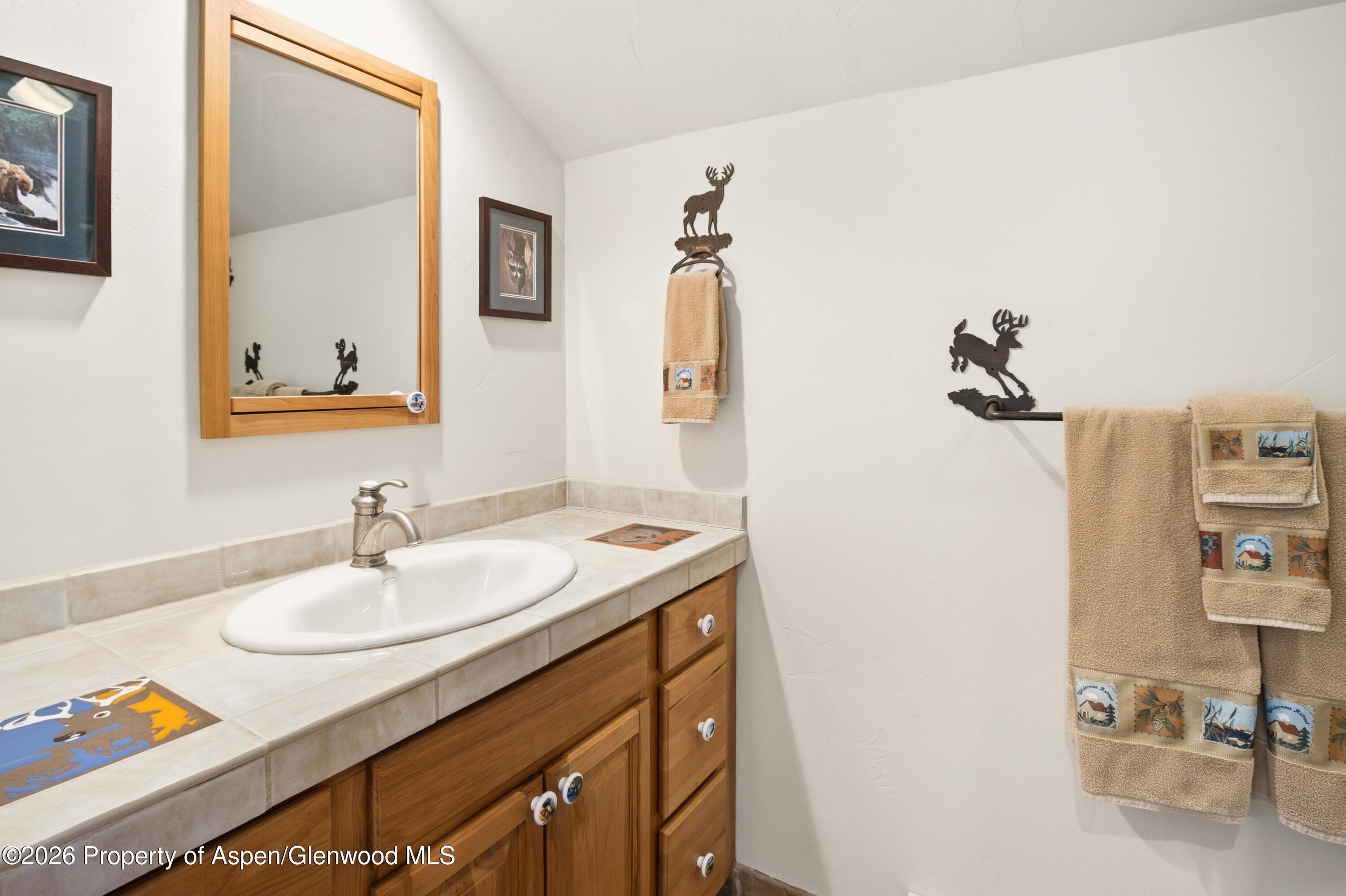 71 River View Place Parachute, CO 81635 - Photo 21 of 45 a bathroom with a sink vanity and a mirror