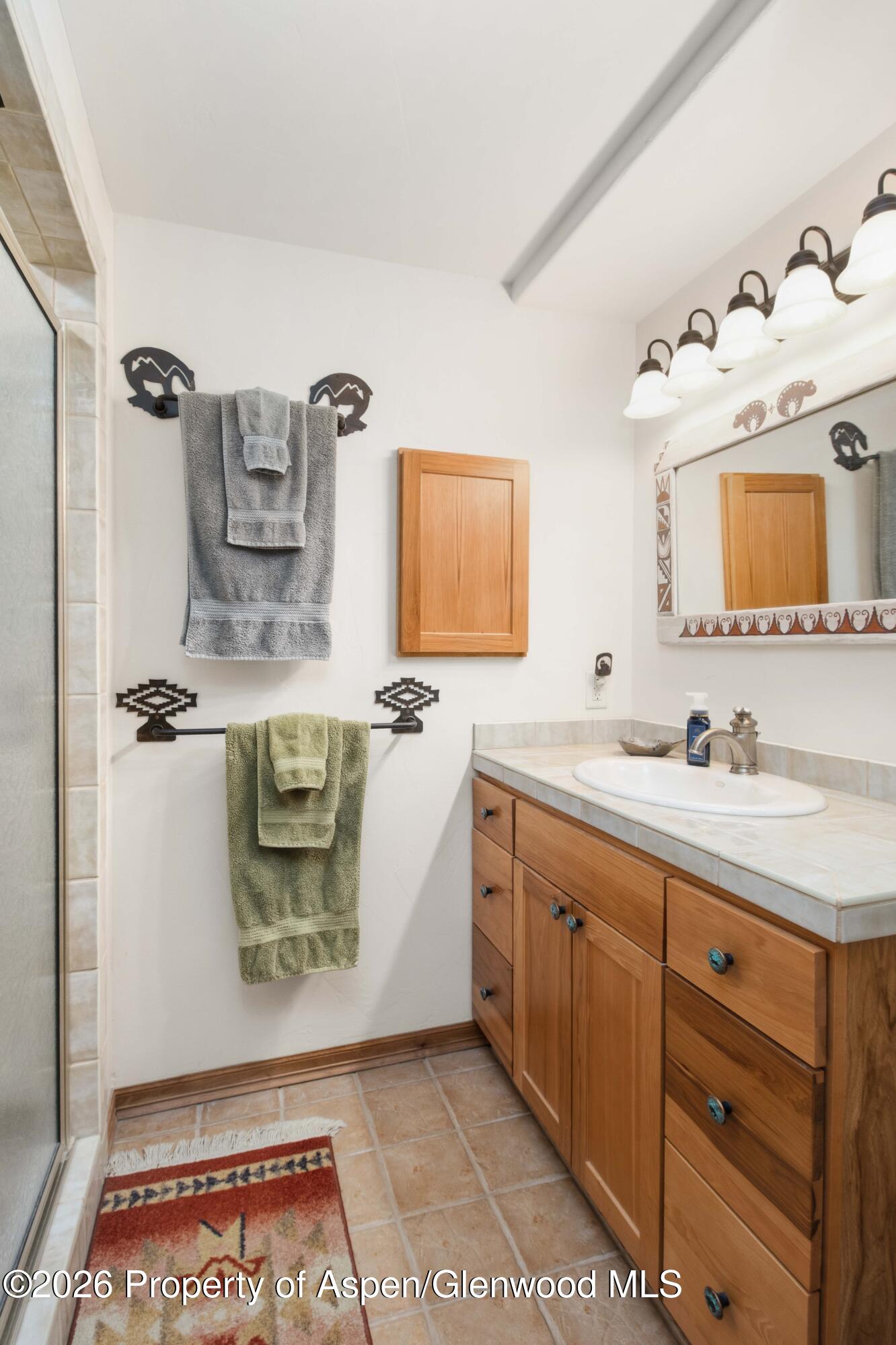 71 River View Place Parachute, CO 81635 - Photo 26 of 45 a bathroom with a sink and a mirror