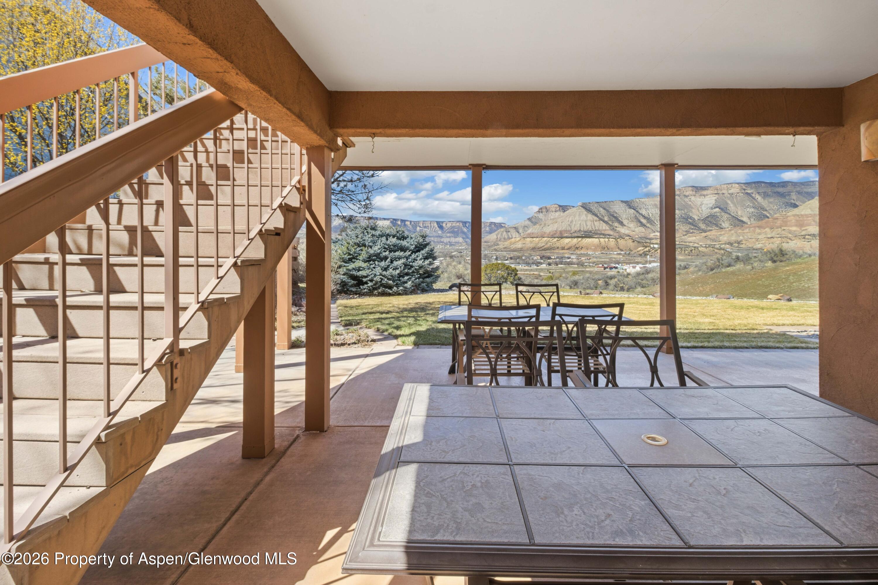 71 River View Place Parachute, CO 81635 - Photo 33 of 45 a view of a dining room with furniture large windows and plants
