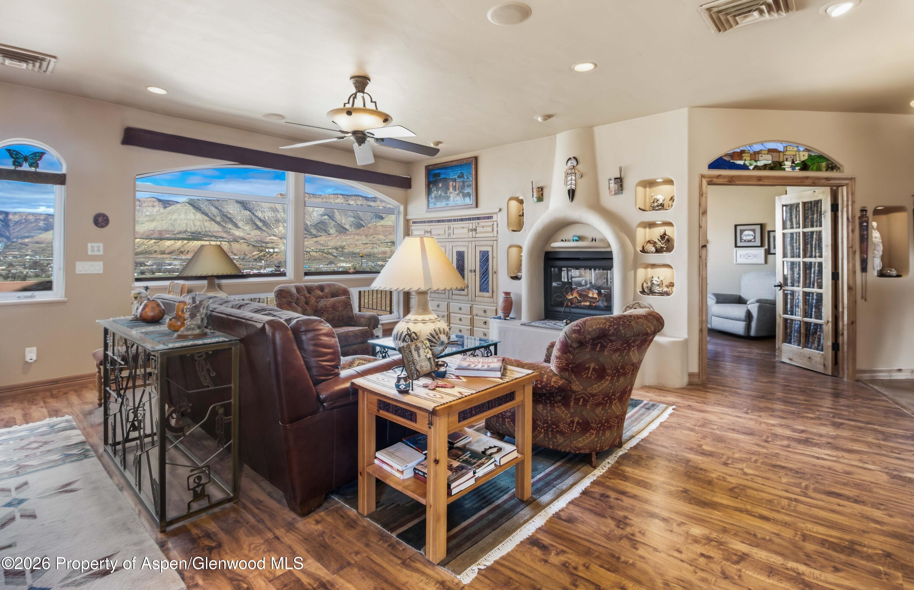 71 River View Place Parachute, CO 81635 - Photo 5 of 45 a living room with furniture a fireplace and a chandelier
