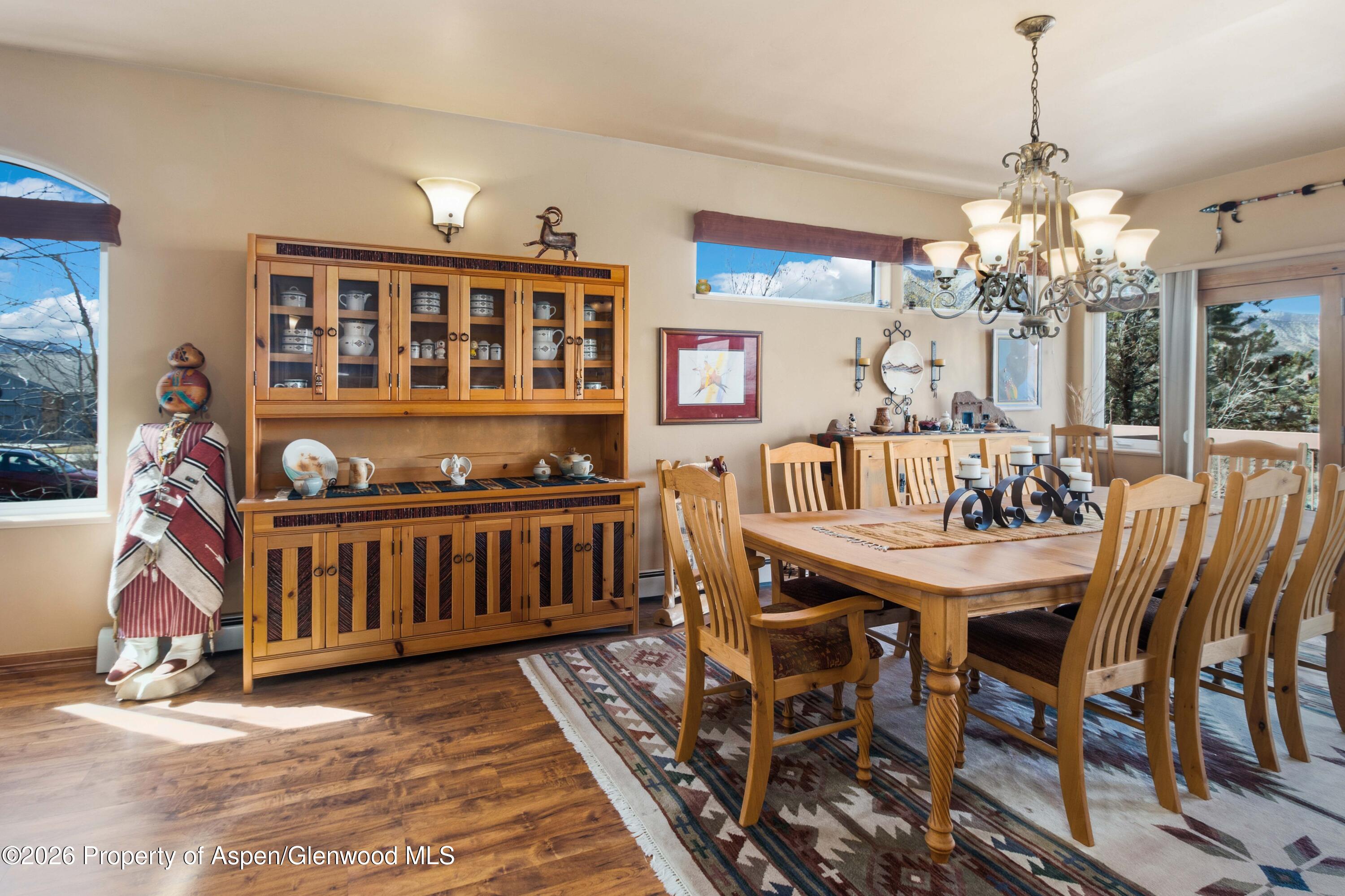 71 River View Place Parachute, CO 81635 - Photo 7 of 45 a view of a dining room with furniture a chandelier and wooden floor