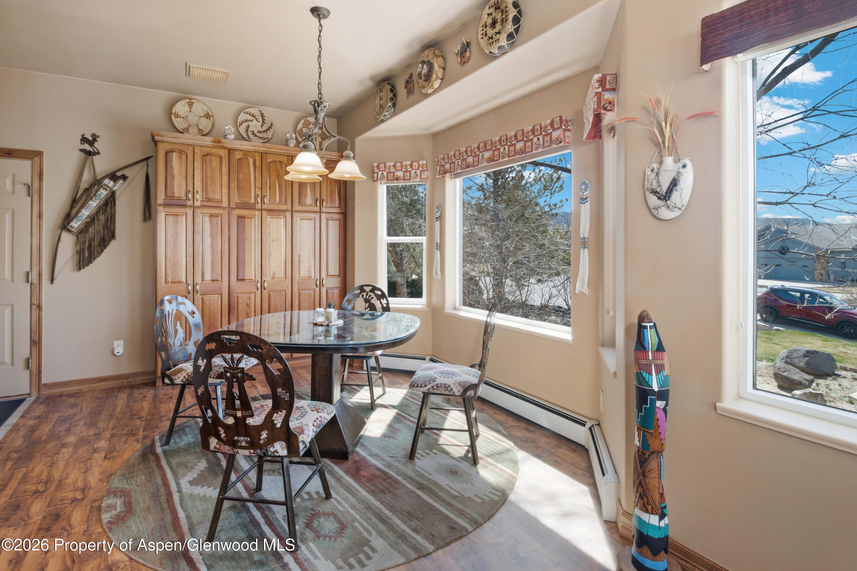71 River View Place Parachute, CO 81635 - Photo 9 of 45 a view of a dining room with furniture window and wooden floor