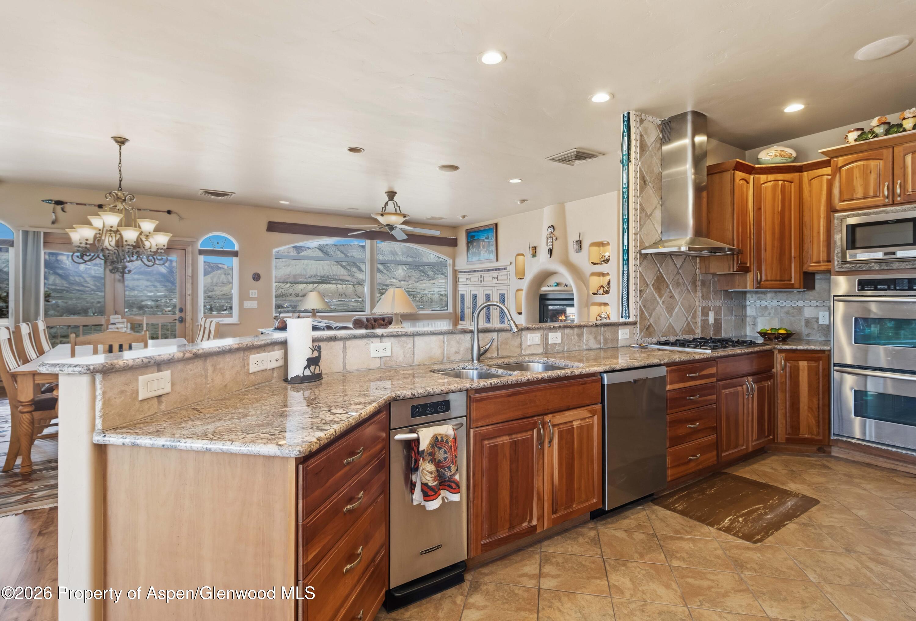 71 River View Place Parachute, CO 81635 - Photo 10 of 45 a kitchen with stainless steel appliances granite countertop a sink counter space cabinets and a fireplace