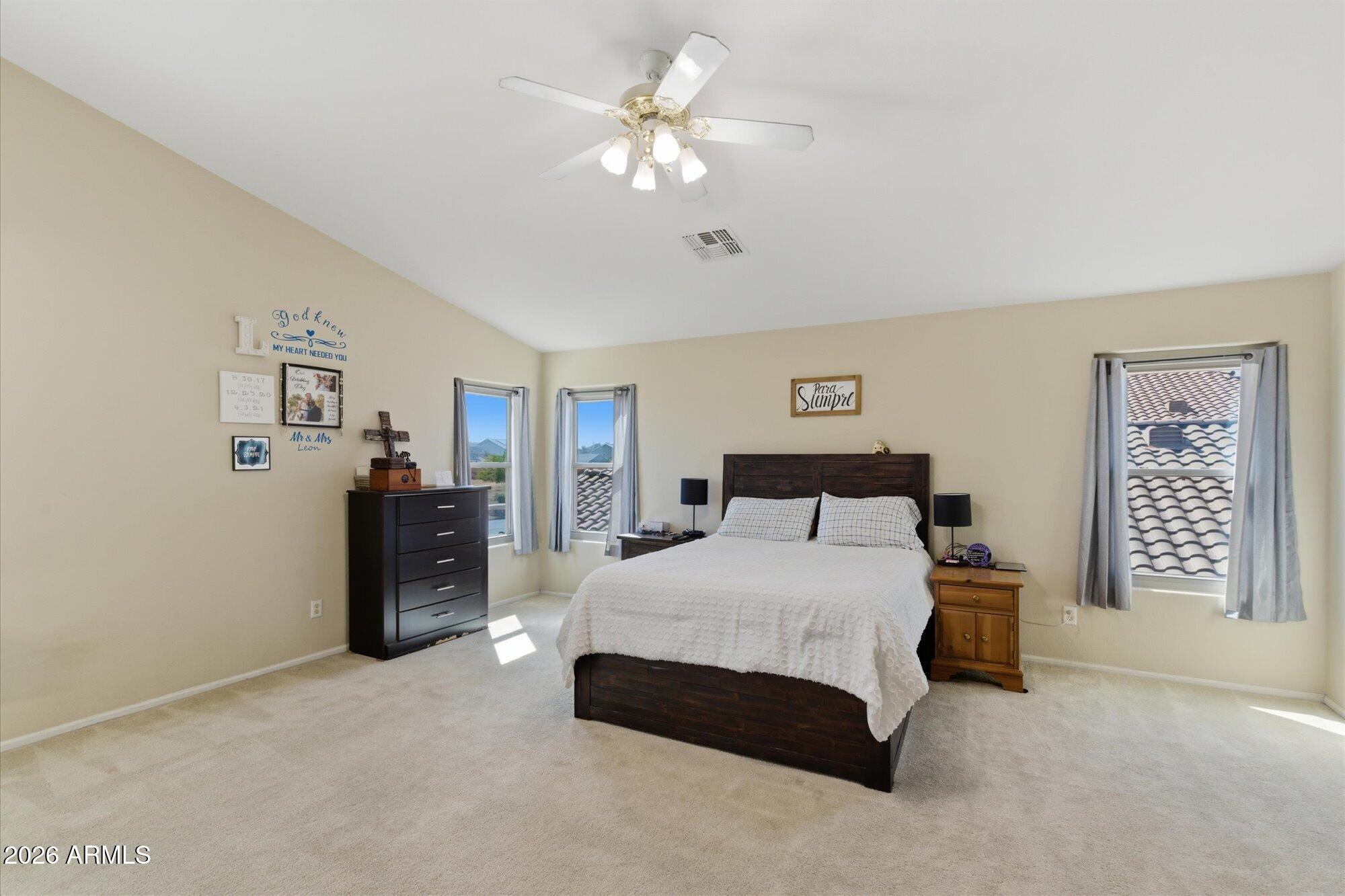 21915 Dietz Drive Maricopa, AZ 85138 - Photo 15 of 31 a spacious bedroom with a bed and a chandelier