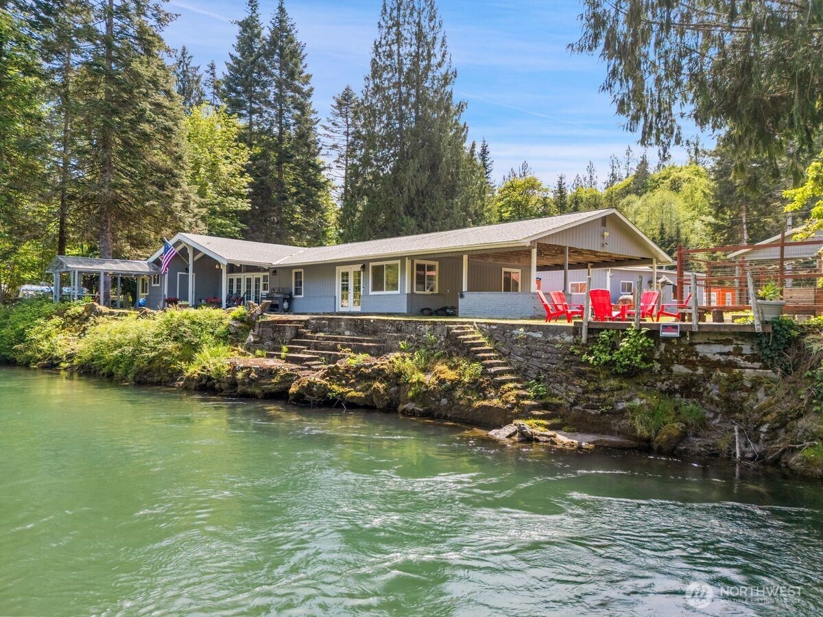 560 Mountain Trail Road Brinnon, WA 98320 - Photo 1 of 40 a view of a house with swimming pool and a yard