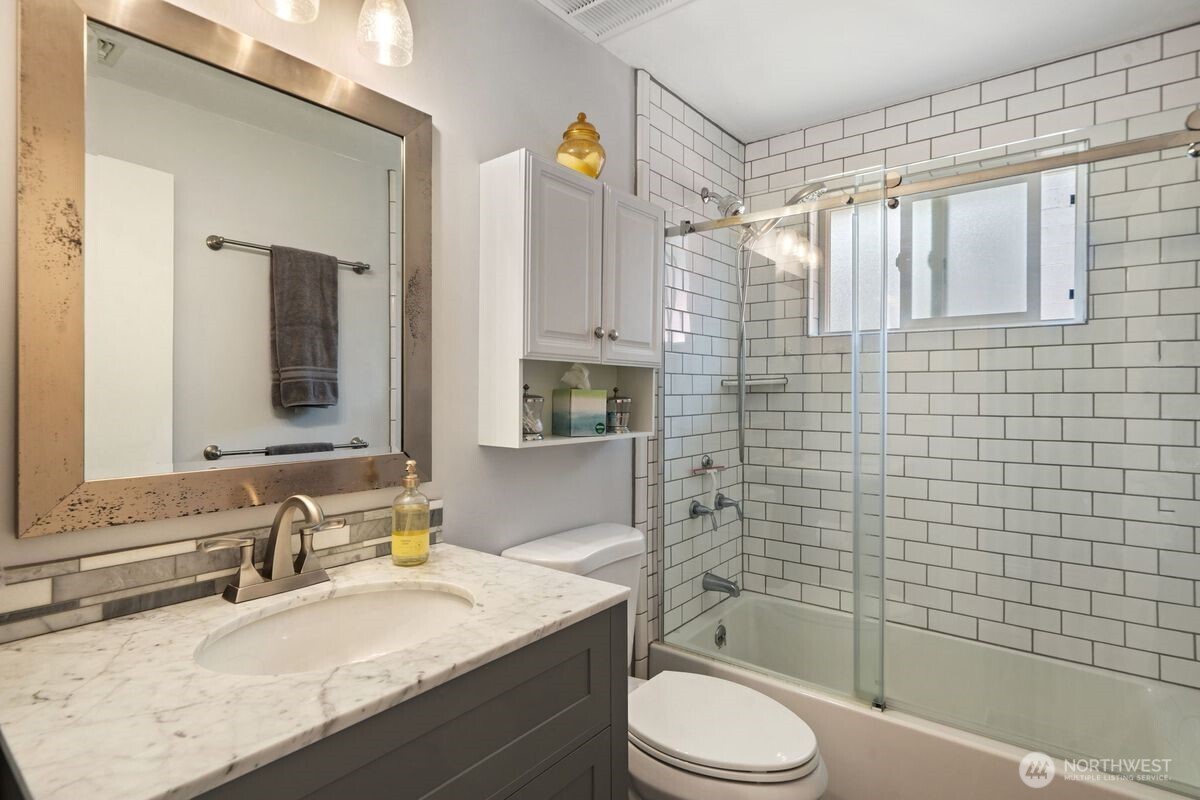 560 Mountain Trail Road Brinnon, WA 98320 - Photo 15 of 40 a bathroom with a granite countertop sink toilet and shower