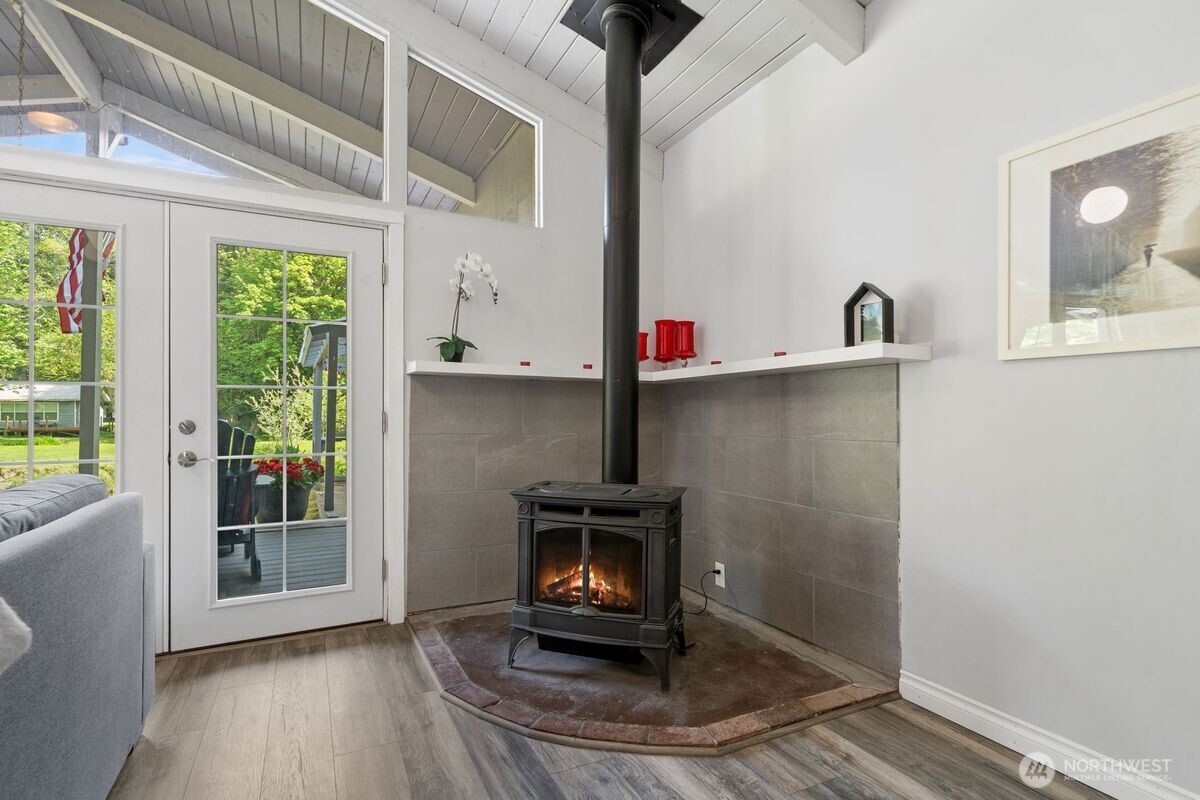 560 Mountain Trail Road Brinnon, WA 98320 - Photo 18 of 40 a room with a potted plant and a wooden floor