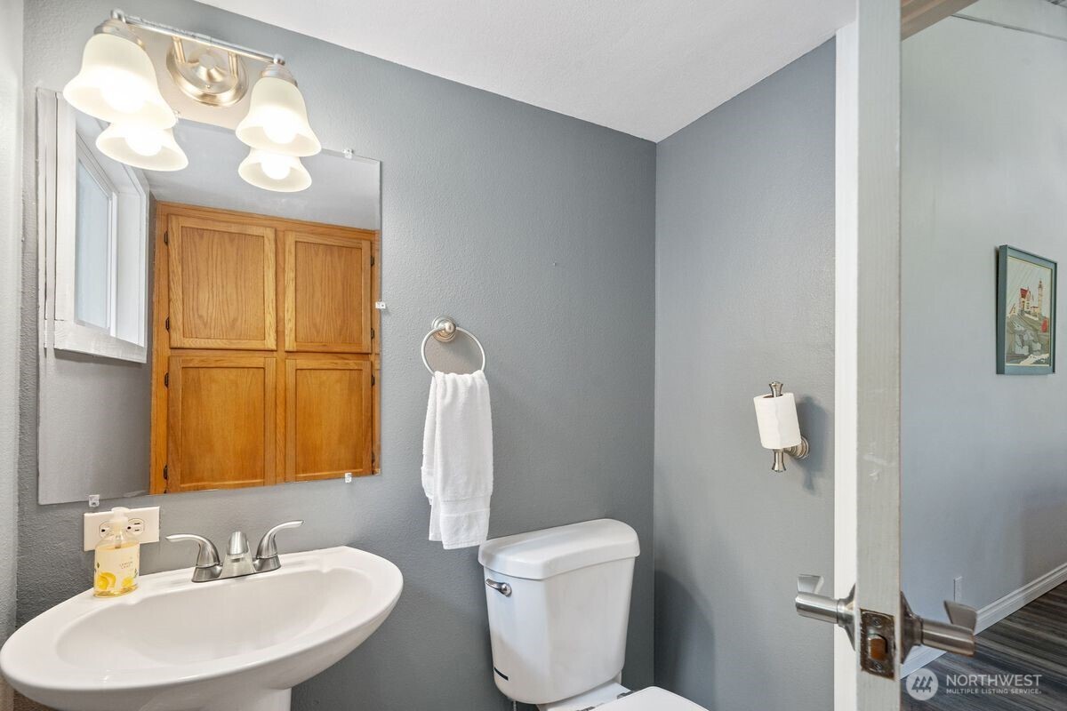 560 Mountain Trail Road Brinnon, WA 98320 - Photo 20 of 40 a bathroom with a sink a toilet and a mirror