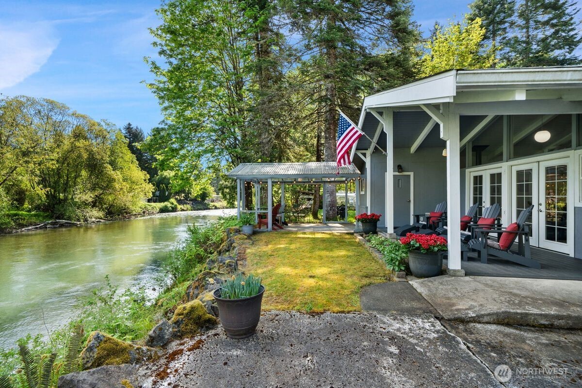 560 Mountain Trail Road Brinnon, WA 98320 - Photo 2 of 40 a view of a house with swimming pool next to a yard