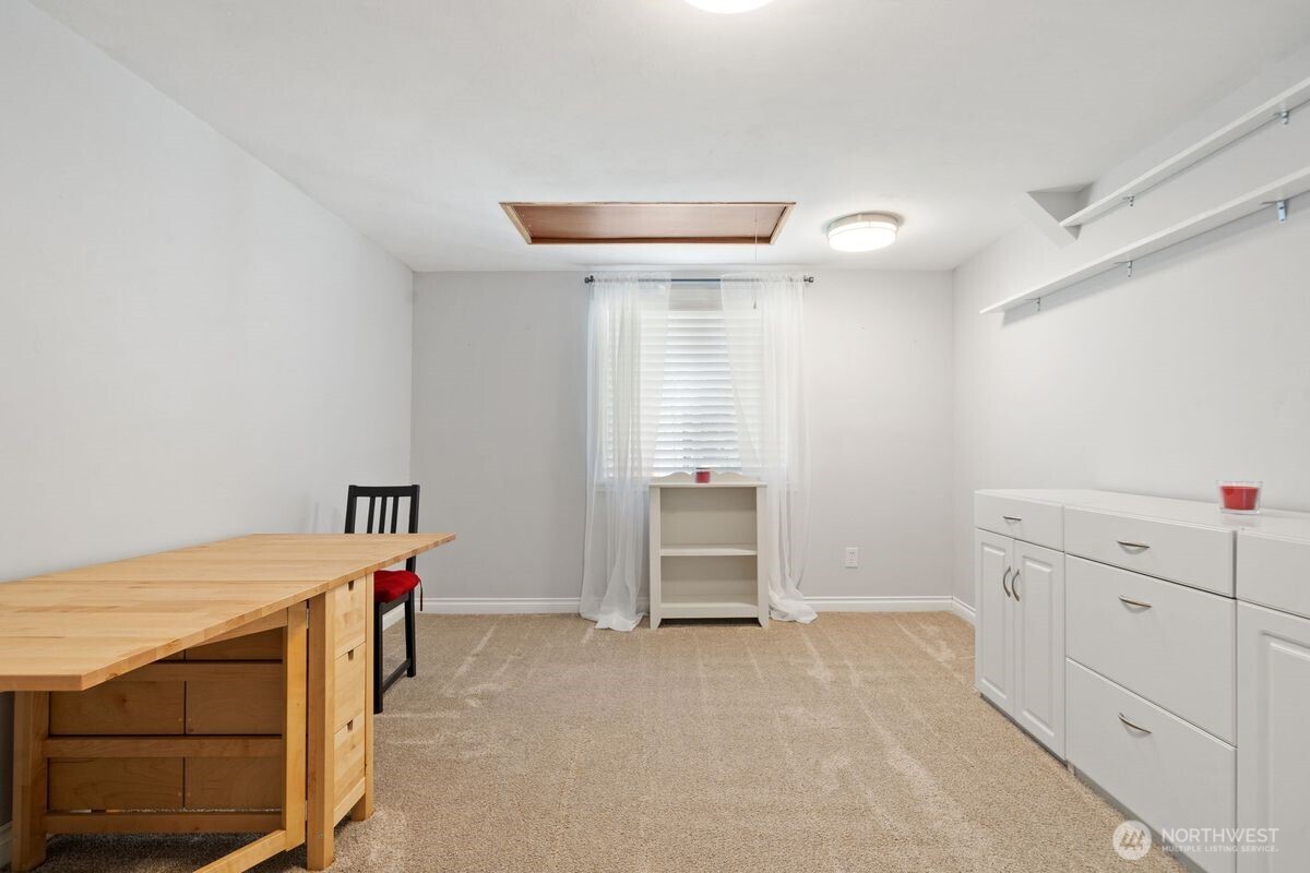 560 Mountain Trail Road Brinnon, WA 98320 - Photo 21 of 40 a room that has a bed and a desk in it