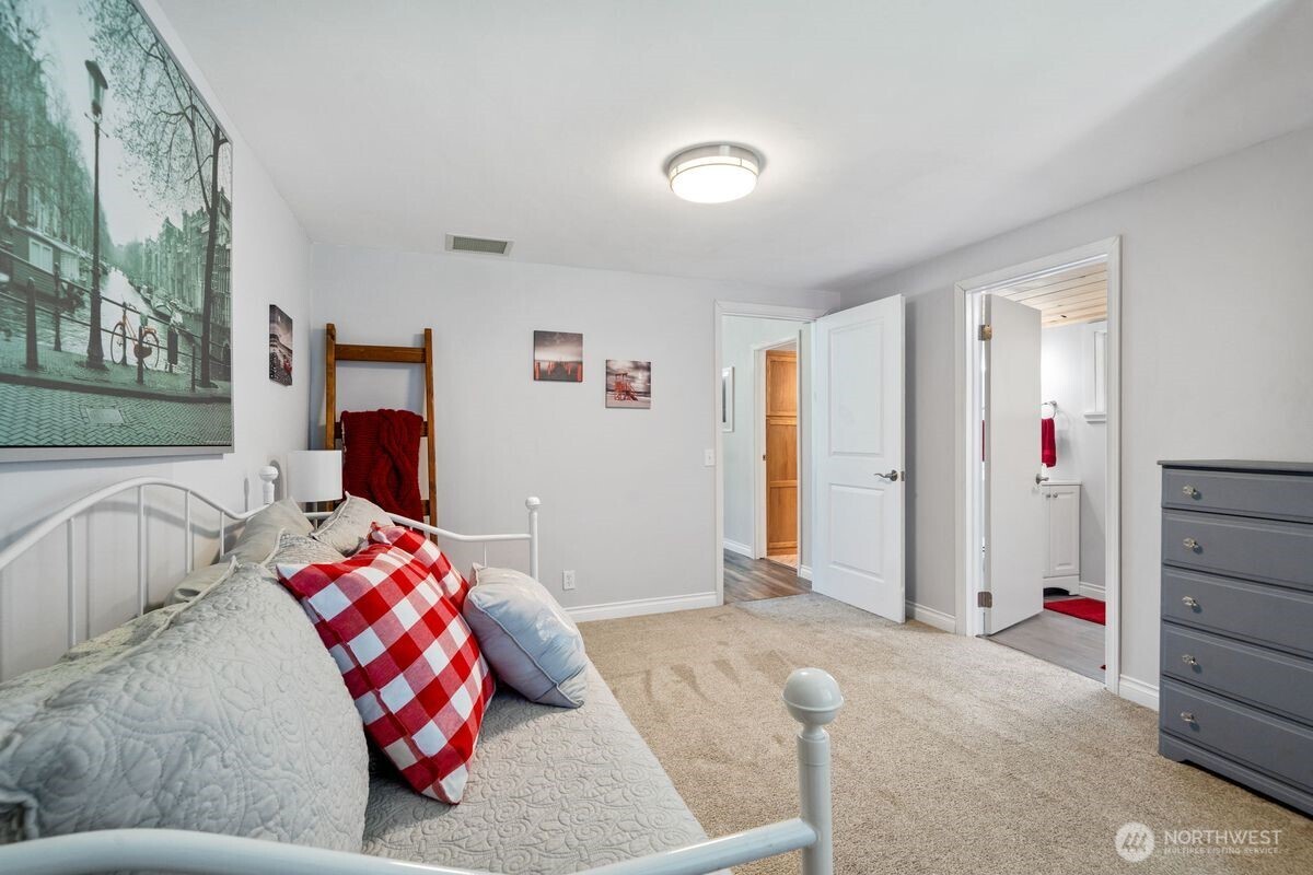 560 Mountain Trail Road Brinnon, WA 98320 - Photo 23 of 40 a bedroom with a bed and a window