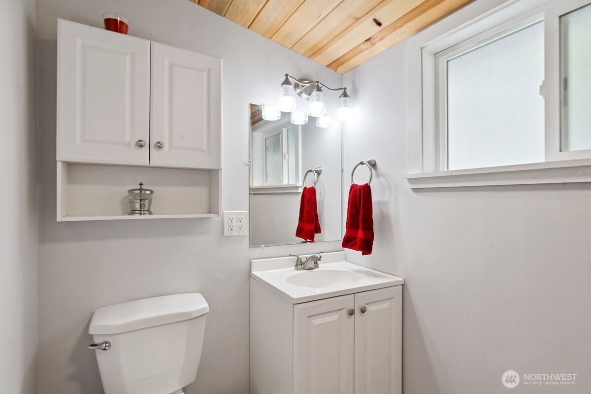 560 Mountain Trail Road Brinnon, WA 98320 - Photo 25 of 40 a bathroom with a sink vanity and toilet