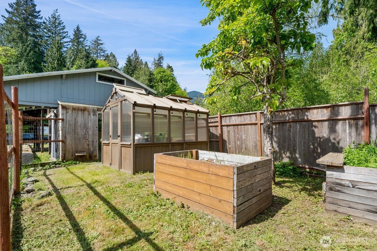 560 Mountain Trail Road Brinnon, WA 98320 - Photo 35 of 40 a view of a backyard with chairs and a patio