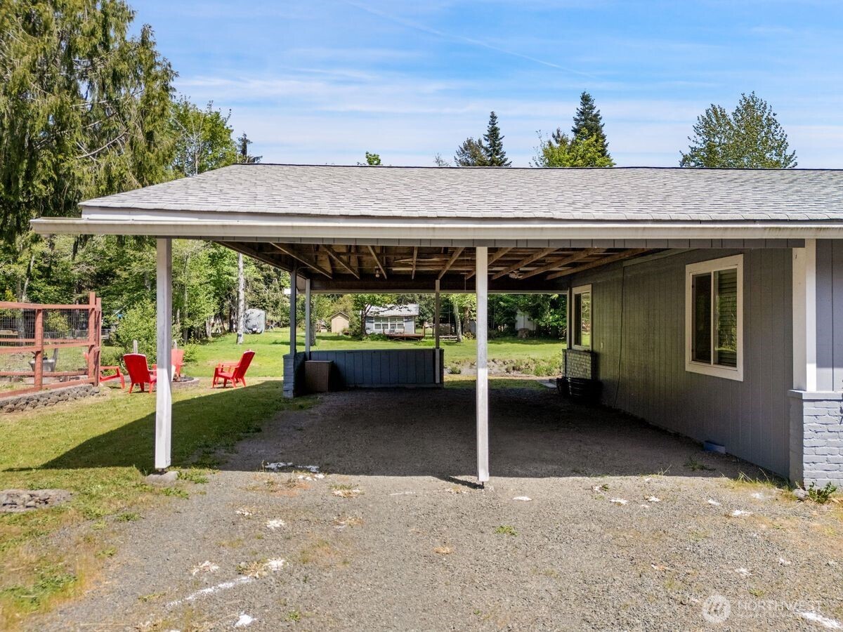 560 Mountain Trail Road Brinnon, WA 98320 - Photo 36 of 40 a backyard of a house with barbeque oven table and chairs