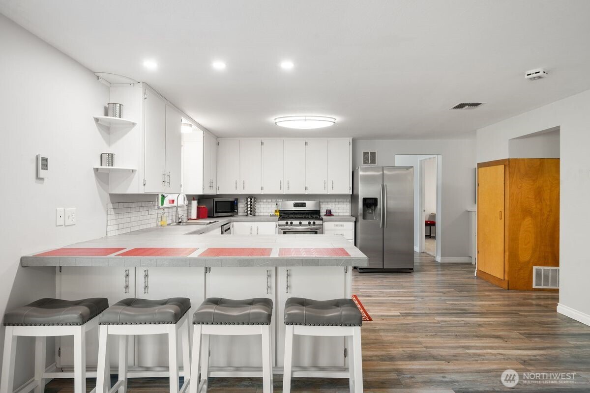 560 Mountain Trail Road Brinnon, WA 98320 - Photo 10 of 40 a large kitchen with a table and chairs
