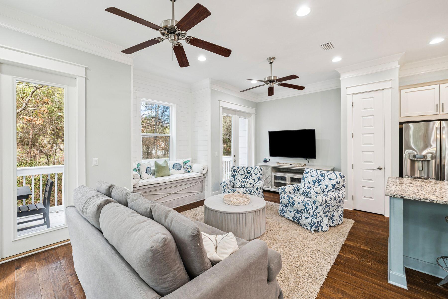 167 Milestone Drive, Unit A Inlet Beach, FL 32461 - Photo 11 of 29 a living room with furniture a ceiling fan and a flat screen tv