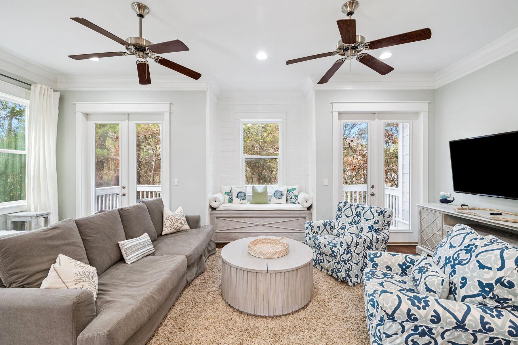 167 Milestone Drive, Unit A Inlet Beach, FL 32461 - Photo 12 of 29 a living room with furniture a flat screen tv and a large window
