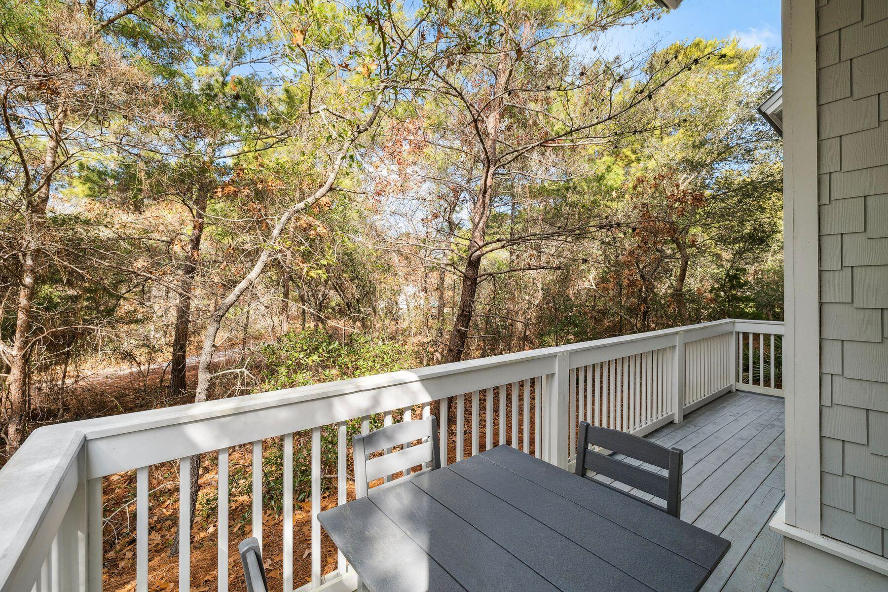 167 Milestone Drive, Unit A Inlet Beach, FL 32461 - Photo 16 of 29 a view of balcony with wooden floor and fence